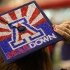 A decorated graduation cap with the University of Arizona “A” logo, red rays, and the words “BEAR DOWN” spelled out in rhinestones.