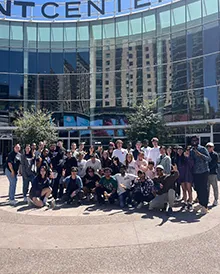 Large group of students posing outside the area where the Phoenix Suns basketball team plays.