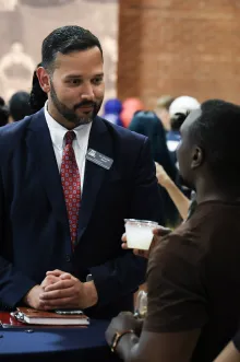 Dr. Saud speaks with a student.