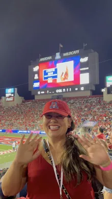 Lysette poses in front of the stadium jumbotron.