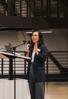 Vice President for Arizona International and Dean of International Education Dr. Jenny Lee address a crowd from a podium. 