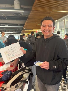 New U of A student holds up bingo card.