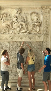 U of A students stand in front of a Roman monument