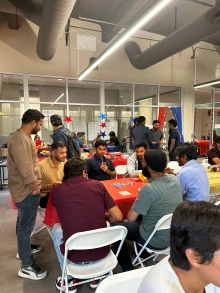 Students gather around a table playing games.