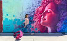Nadia Alvarez Mexia walks by a mural in Tucson painted by Ignacio