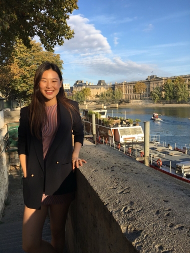 UA Study Abroad Student Stephanie Kim standing with a view of the Seine in Paris behind her.