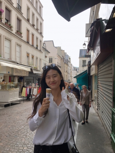 UA Study Abroad Student Stephanie Kim eating an ice cream cone in Paris.