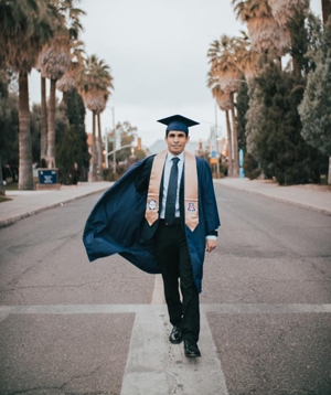 Dual Degree UArizona-UPC student Sebastian Montoya on UA mall in graduation cap and gown Dual Degree UArizona-UPC student Sebastian Montoya on UA mall in graduation cap and gown