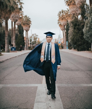 Dual Degree UArizona-UPC student Sebastian Montoya on UA mall in graduation cap and gown