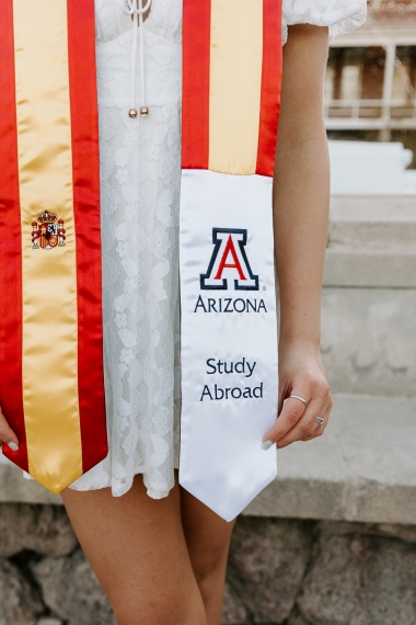 Close up of University of Arizona yellow and red graduation stole with Block A Arizona logo and the words Study Abroad