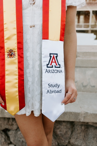 Close up of University of Arizona yellow and red graduation stole with Block A Arizona logo and the words Study Abroad Close up of University of Arizona yellow and red graduation stole with Block A Arizona logo and the words Study Abroad