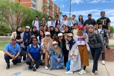 Dennis with large group of international students on a Buddy Program outing