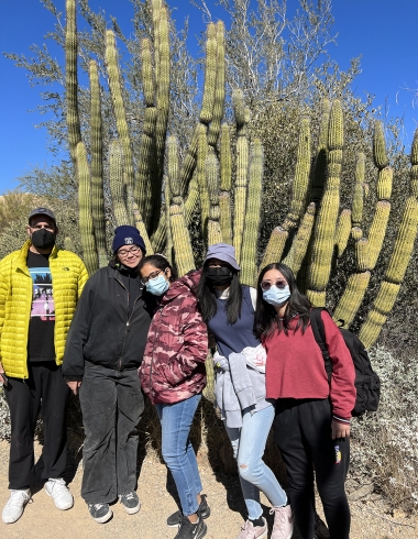 Ananya, Second from right, with a group of international students visiting the Arizona Sonora Desert Museum. The five students are standing in front of a large organ pipe cactus.