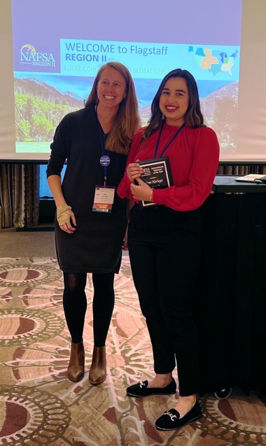 Noriega receives award from Lara Pfaff at NAFSA Region 2 conference