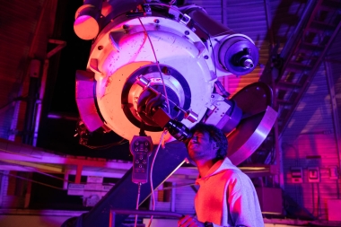 Nikhil Garuda looks through a telescope at the Steward Observatory on the UA campus